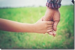 Close up of father holding his daughter hand, so sweet,family time.