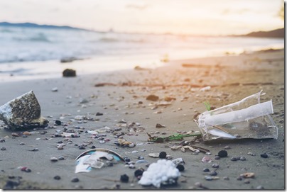 Trash on sand beach showing environmental pollution problem