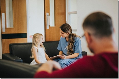 Young girl speaking to a female nurse