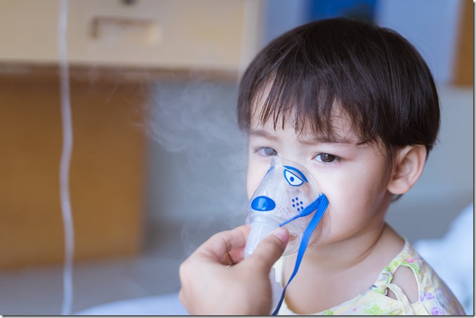 Little Asian boy under anesthesia with an oxygen mask in hospital. 