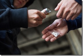 close up of addict buying dose from drug dealer