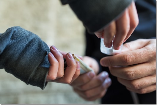 close up of addict buying dose from drug dealer