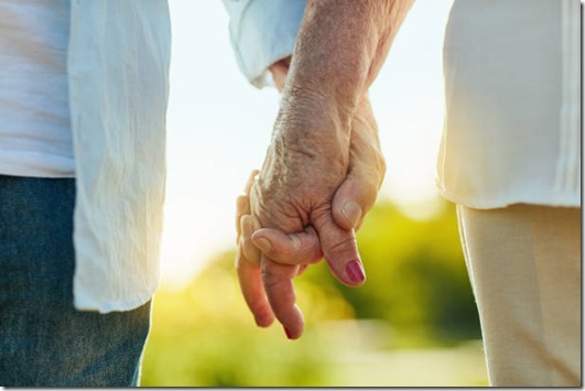 Cropped shot of a senior couple holding hands in a park