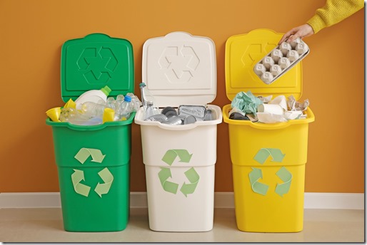 Woman throwing garbage into container. Recycling concept