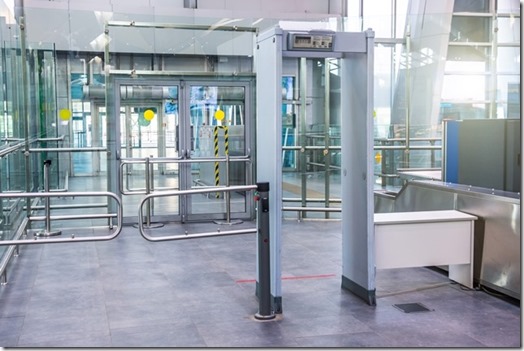 Security checks the metal detector installed at the entrance to a building public place.