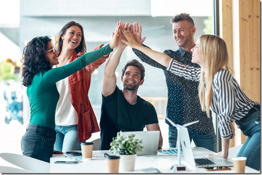 Group of successful smart business team celebrating good job while holding up their right hands on coworking place.