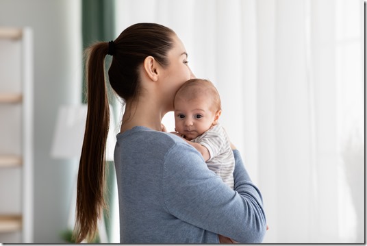 Maternal Mental Health Problems. Young Woman Holding Newborn Baby Standing Near Window