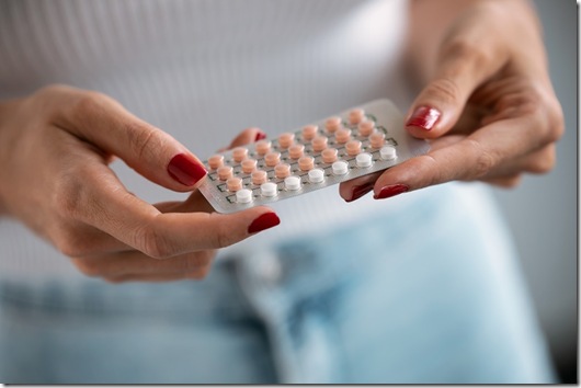 Woman holding a contraceptive pills. Concept of contraception methods.