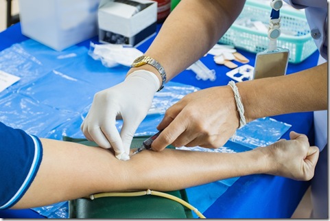 doctor injection needle on arm to collect blood for test the health selective focus syringe