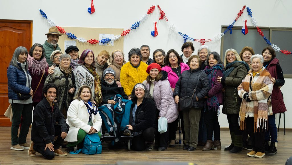 Vecinos de Algarrobo asistiendo a una función de cine chileno en un centro comunitario